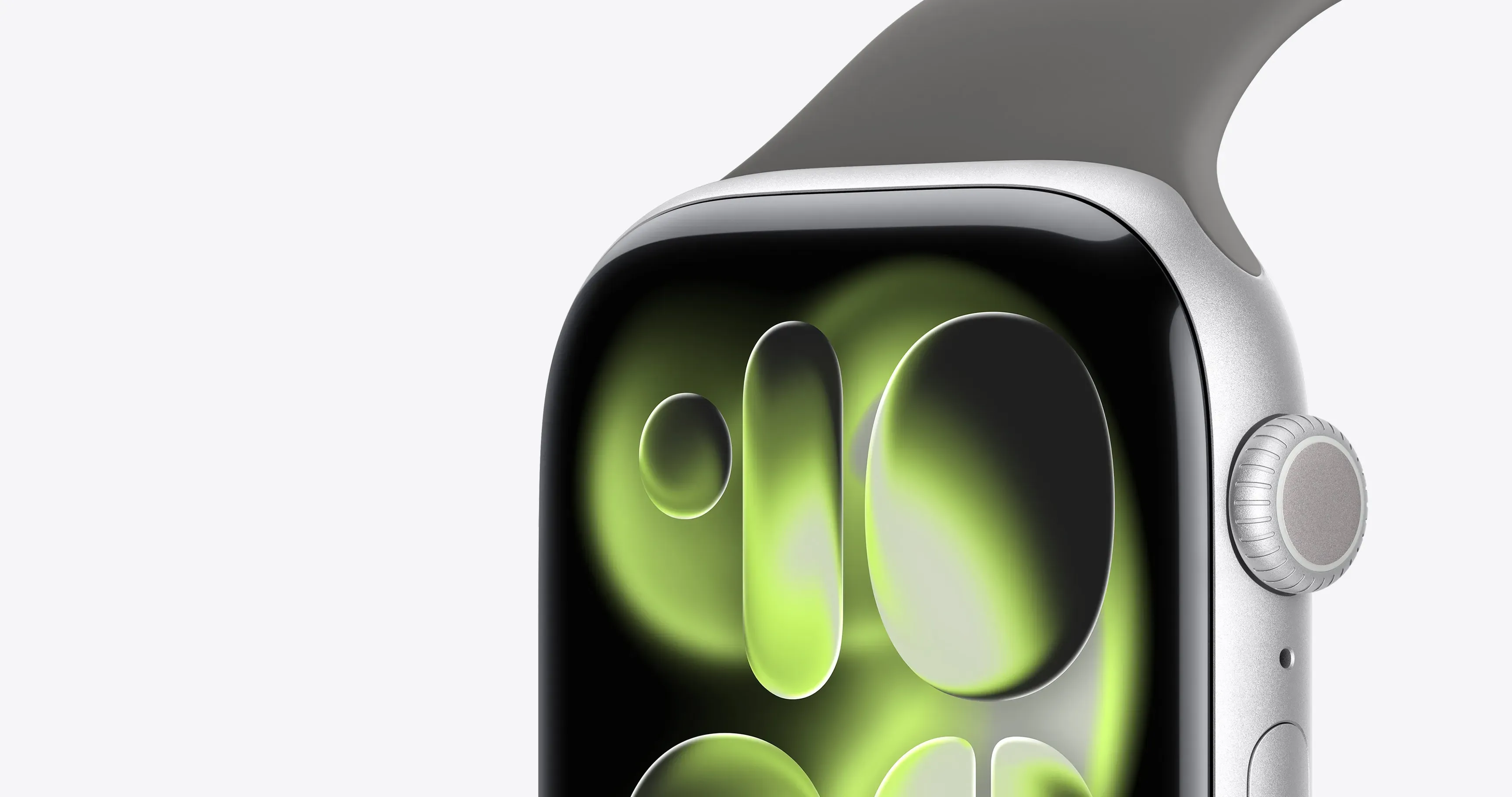 Макро-фото сріблястого Apple Watch: деталізований вигляд дисплея із зеленою заставкою та коліщатка Digital Crown